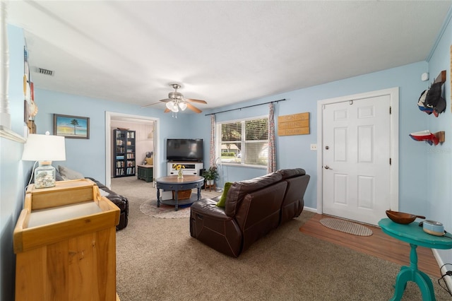 6060 SE 119th Pl, Belleview, FL 34420 - living area with carpet floors and a ceiling fan