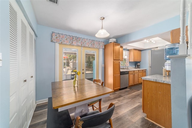 6060 SE 119th Pl, Belleview, FL 34420 - kitchen featuring stainless steel appliances, french doors, light countertops, dark wood finished floors, and hanging light fixtures