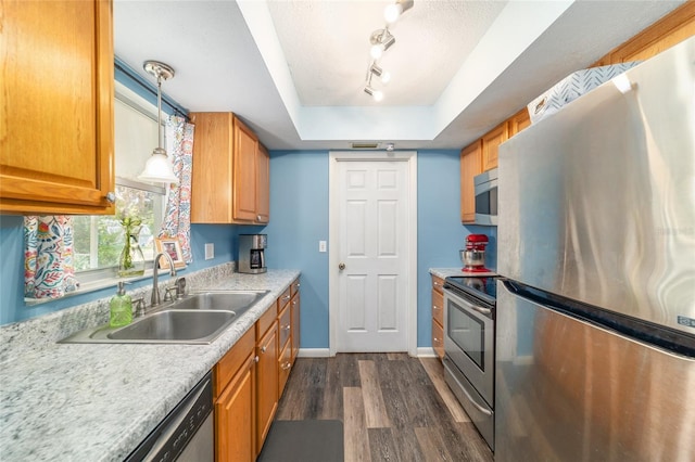 6060 SE 119th Pl, Belleview, FL 34420 - kitchen with appliances with stainless steel finishes, a sink, dark wood-style floors, light countertops, and a raised ceiling