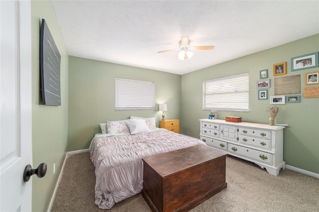 6060 SE 119th Pl, Belleview, FL 34420 - bedroom featuring light colored carpet, baseboards, and ceiling fan