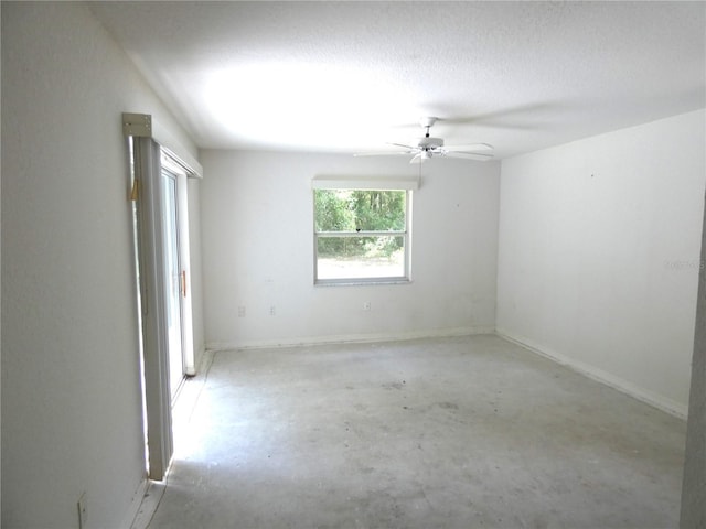 19026 SW 100th Pl, Dunnellon, FL 34432 - empty room with unfinished concrete flooring, ceiling fan, and baseboards