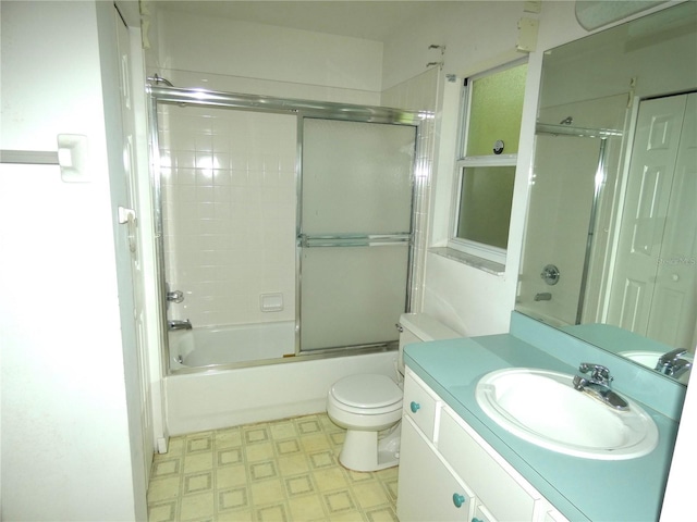 19026 SW 100th Pl, Dunnellon, FL 34432 - full bathroom featuring toilet, tile patterned floors, vanity, and bath / shower combo with glass door