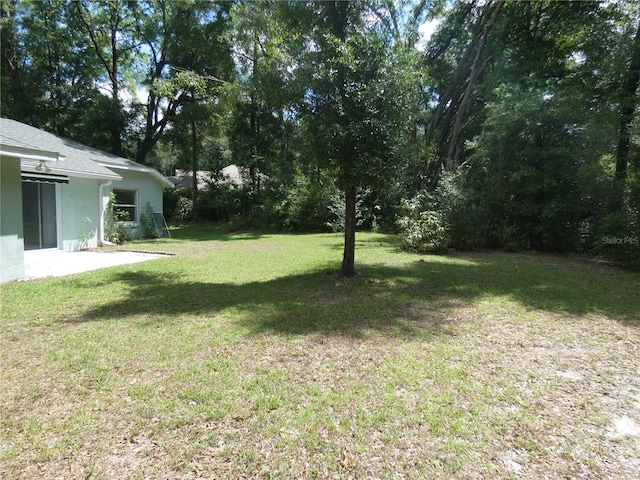 19026 SW 100th Pl, Dunnellon, FL 34432 - view of green lawn featuring a patio area
