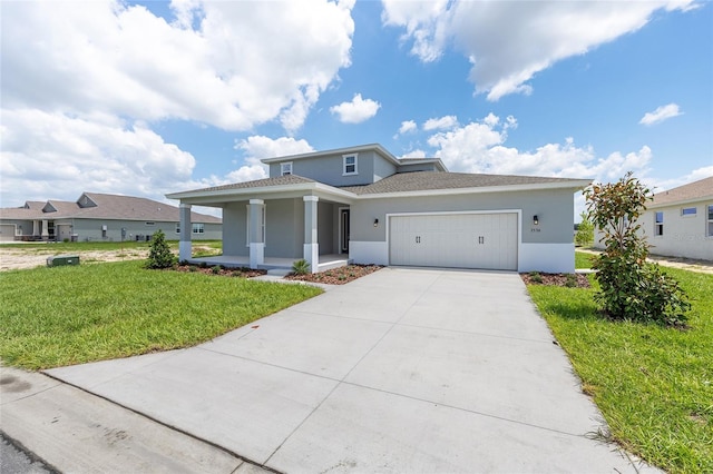 7536 SW 60th St, Ocala, FL 34476 - view of front of house featuring stucco siding, a porch, an attached garage, a front lawn, and driveway