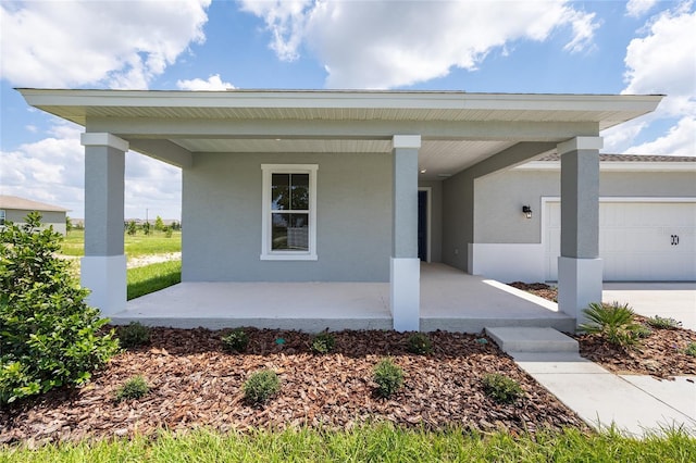 7536 SW 60th St, Ocala, FL 34476 - view of front of property featuring a porch, stucco siding, and an attached garage
