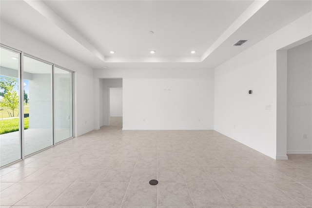 7536 SW 60th St, Ocala, FL 34476 - spare room with a tray ceiling, light tile patterned floors, recessed lighting, and baseboards