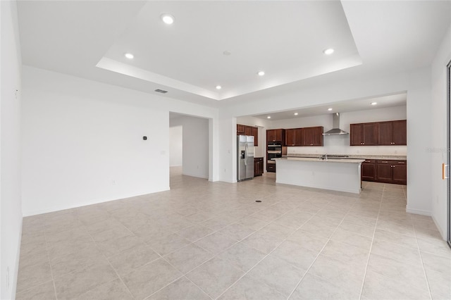 7536 SW 60th St, Ocala, FL 34476 - unfurnished living room featuring recessed lighting, a tray ceiling, light tile patterned floors, and baseboards