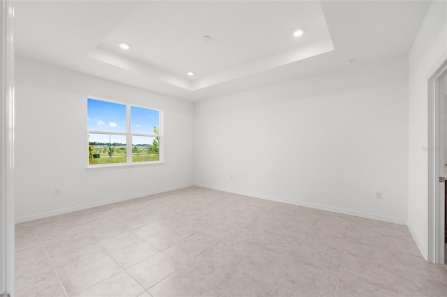 7536 SW 60th St, Ocala, FL 34476 - unfurnished room with recessed lighting, a tray ceiling, baseboards, and light tile patterned flooring