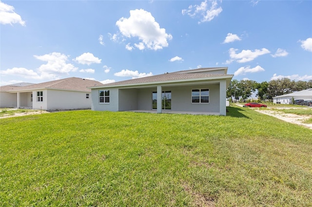 7536 SW 60th St, Ocala, FL 34476 - back of property featuring stucco siding and a yard