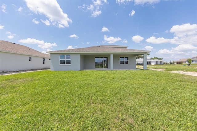 7536 SW 60th St, Ocala, FL 34476 - rear view of house featuring stucco siding and a yard