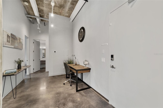302 SE Broadway St Unit 240, Ocala, FL 34471 - hallway featuring finished concrete floors, a towering ceiling, and an office area