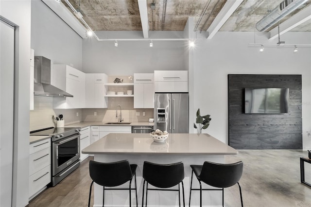 302 SE Broadway St Unit 240, Ocala, FL 34471 - kitchen with stainless steel appliances, track lighting, wall chimney exhaust hood, and a sink