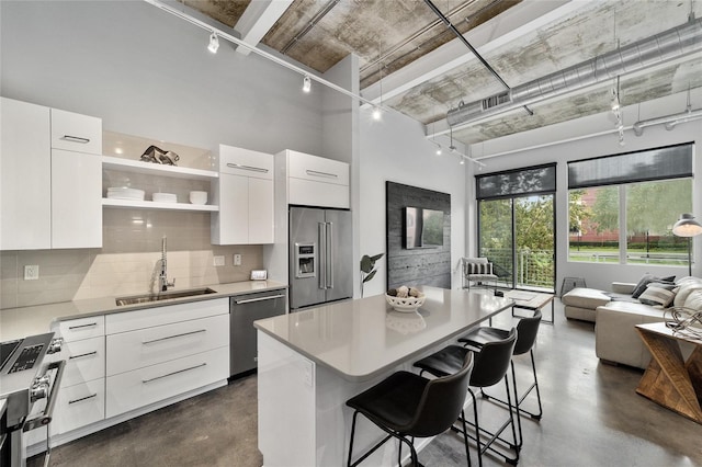 302 SE Broadway St Unit 240, Ocala, FL 34471 - kitchen featuring high quality appliances, concrete flooring, modern cabinets, track lighting, and a sink