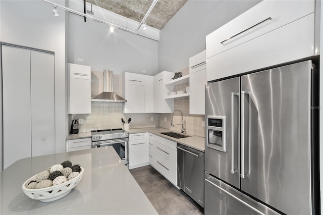 302 SE Broadway St Unit 240, Ocala, FL 34471 - kitchen featuring stainless steel appliances, wall chimney exhaust hood, a sink, open shelves, and decorative backsplash