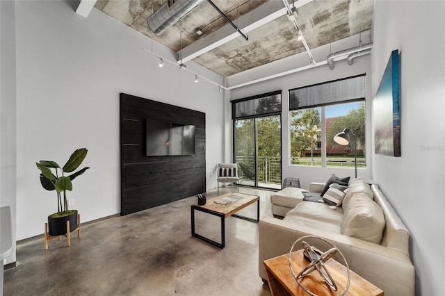 302 SE Broadway St Unit 240, Ocala, FL 34471 - living area with concrete floors and rail lighting