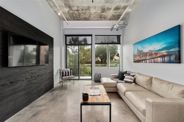 302 SE Broadway St Unit 240, Ocala, FL 34471 - living area featuring concrete flooring, track lighting, and a high ceiling