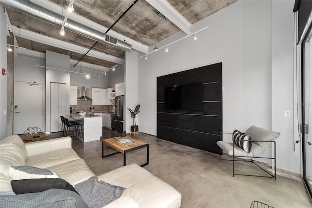 302 SE Broadway St Unit 240, Ocala, FL 34471 - living area with a high ceiling and finished concrete floors