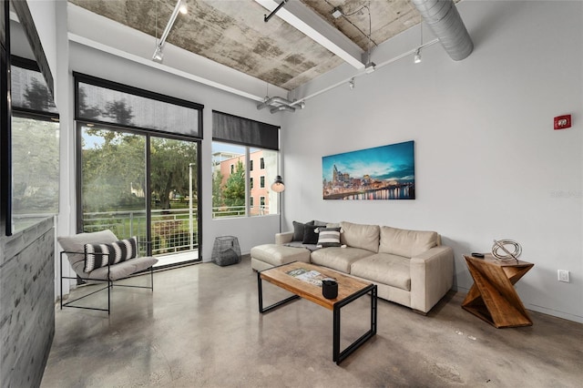 302 SE Broadway St Unit 240, Ocala, FL 34471 - living area with finished concrete floors and rail lighting