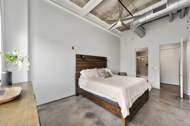 302 SE Broadway St Unit 240, Ocala, FL 34471 - bedroom with concrete flooring, a towering ceiling, baseboards, and connected bathroom
