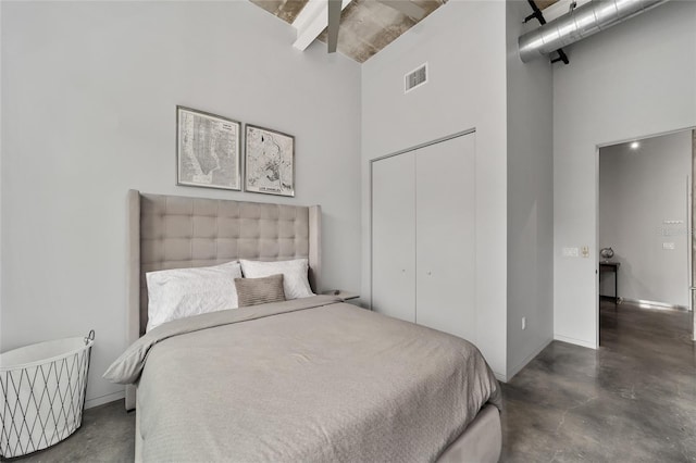 302 SE Broadway St Unit 240, Ocala, FL 34471 - bedroom featuring a high ceiling, concrete floors, beam ceiling, and a closet