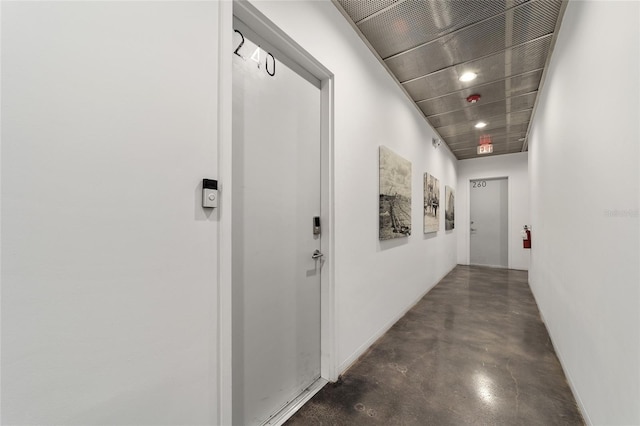 302 SE Broadway St Unit 240, Ocala, FL 34471 - hallway with finished concrete flooring and baseboards