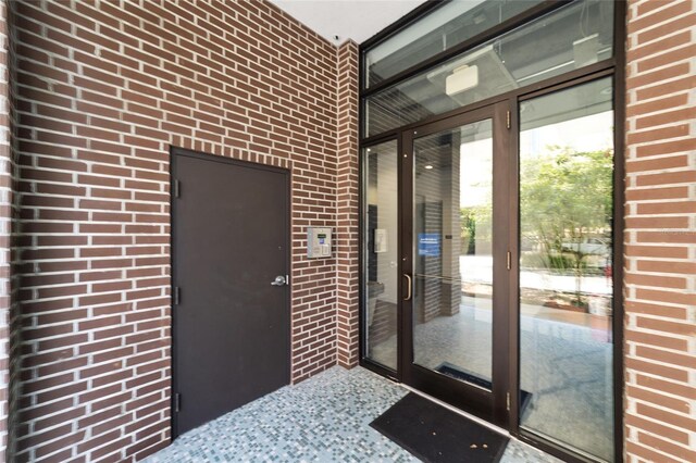 302 SE Broadway St Unit 240, Ocala, FL 34471 - doorway to property with brick siding