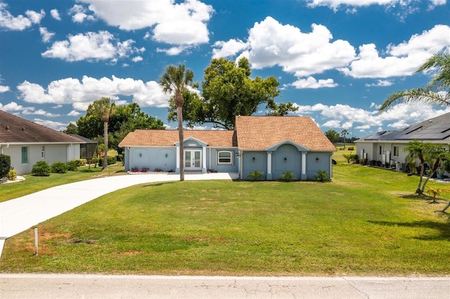 view of front of home featuring french doors, concrete driveway, and a front lawn