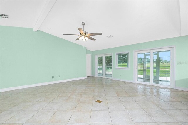 spare room with ceiling fan, light tile patterned flooring, and baseboards