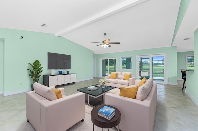 living area featuring light tile patterned flooring, a ceiling fan, and baseboards