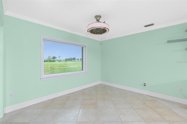 unfurnished room with crown molding, baseboards, and light tile patterned floors