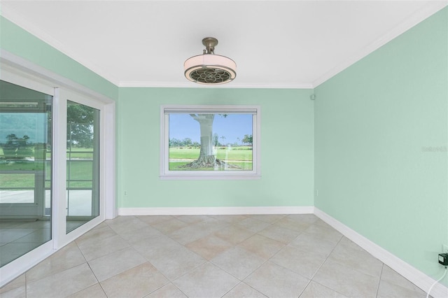 spare room with crown molding, baseboards, and light tile patterned floors
