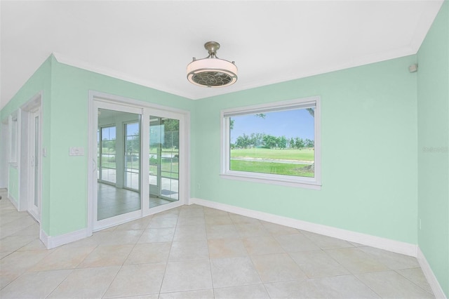 empty room with baseboards and light tile patterned flooring