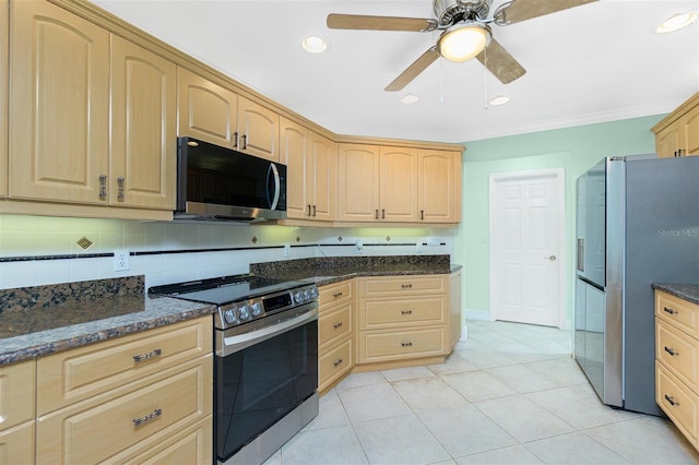 kitchen with appliances with stainless steel finishes, light brown cabinets, ceiling fan, backsplash, and dark stone countertops