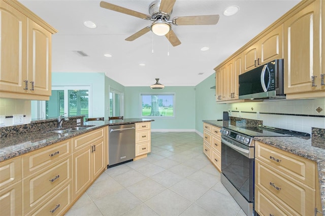 kitchen with appliances with stainless steel finishes, light brown cabinets, tasteful backsplash, a ceiling fan, and recessed lighting