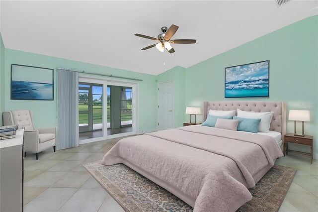 bedroom with vaulted ceiling, access to exterior, light tile patterned floors, and a ceiling fan
