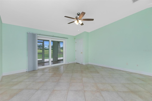 unfurnished room featuring ceiling fan, lofted ceiling, baseboards, and light tile patterned flooring