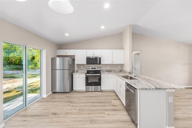 17645 SW 112th Ln, Dunnellon, FL 34432 - kitchen with appliances with stainless steel finishes, a sink, a peninsula, light stone countertops, and white cabinets