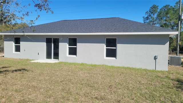 17645 SW 112th Ln, Dunnellon, FL 34432 - back of property with cooling unit, stucco siding, a lawn, and a shingled roof