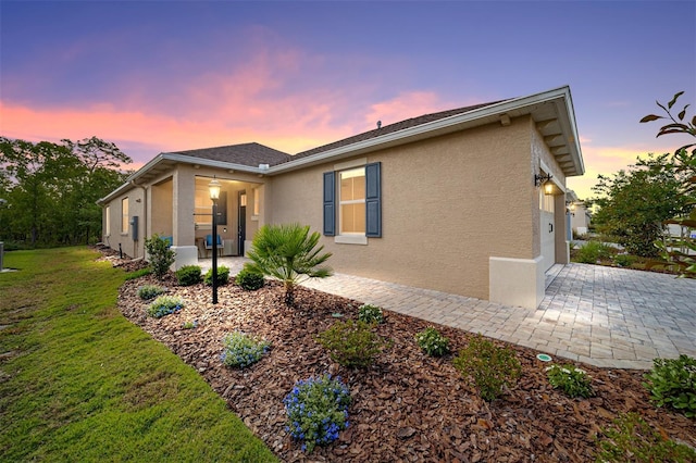 9309 SW 106th Ave, Ocala, FL 34481 - view of front facade with stucco siding and a lawn