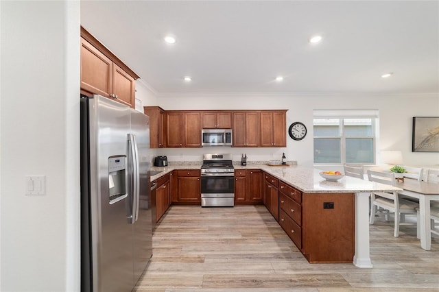 9309 SW 106th Ave, Ocala, FL 34481 - kitchen with appliances with stainless steel finishes, a peninsula, brown cabinetry, crown molding, and recessed lighting
