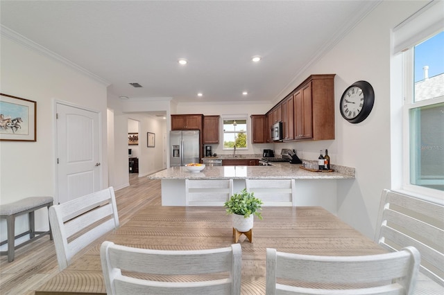 9309 SW 106th Ave, Ocala, FL 34481 - dining area featuring light wood-style flooring, crown molding, recessed lighting, and baseboards