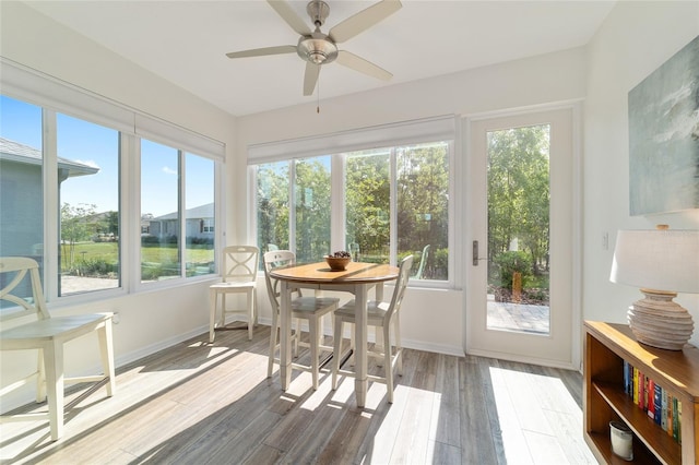 9309 SW 106th Ave, Ocala, FL 34481 - sunroom / solarium featuring a deck, wood finished floors, and baseboards