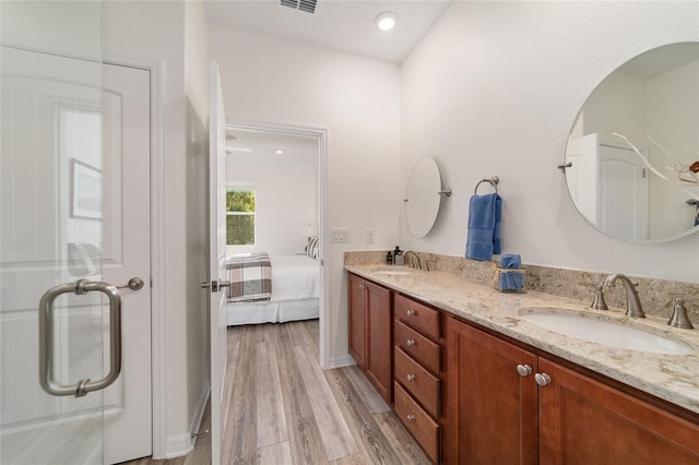 9309 SW 106th Ave, Ocala, FL 34481 - ensuite bathroom featuring wood finished floors, double vanity, and recessed lighting