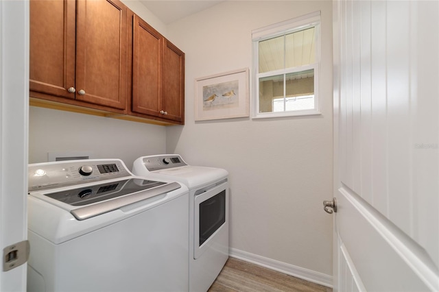 9309 SW 106th Ave, Ocala, FL 34481 - laundry room with washing machine and dryer, cabinet space, light wood-style floors, and baseboards