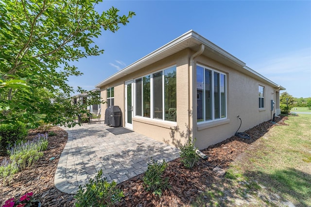 9309 SW 106th Ave, Ocala, FL 34481 - rear view of house featuring stucco siding and a patio