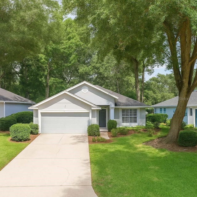 8926 SW 192nd Court Rd, Dunnellon, FL 34432 - ranch-style house featuring an attached garage, a front lawn, concrete driveway, and stucco siding