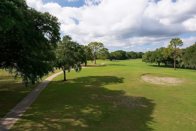 8926 SW 192nd Court Rd, Dunnellon, FL 34432 - surrounding community with view of wooded area, a lawn, and golf course view