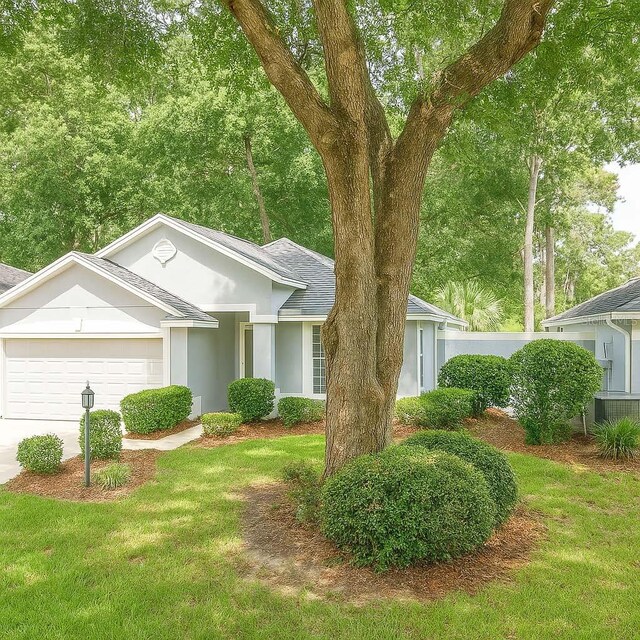 8926 SW 192nd Court Rd, Dunnellon, FL 34432 - ranch-style home with a garage, roof with shingles, stucco siding, central AC, and concrete driveway