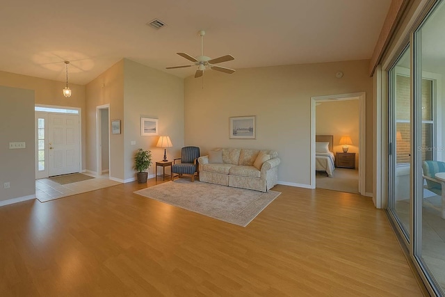 8926 SW 192nd Court Rd, Dunnellon, FL 34432 - living area with light wood finished floors, ceiling fan, baseboards, and high vaulted ceiling