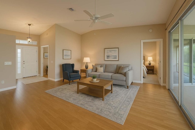 8926 SW 192nd Court Rd, Dunnellon, FL 34432 - living room featuring light wood-style flooring, ceiling fan, baseboards, and lofted ceiling